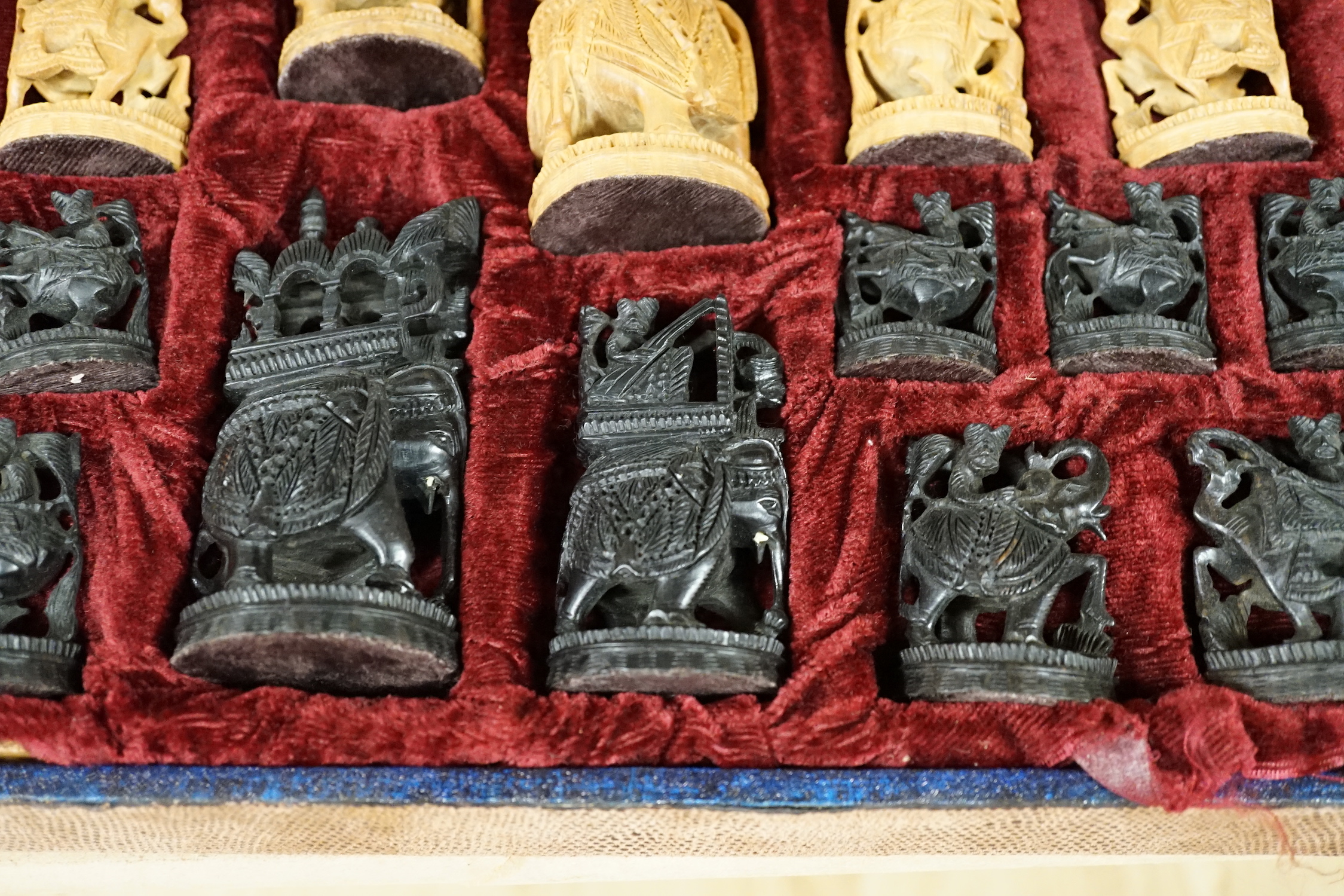 A cased Indian sandalwood and ebony figural chess set, case 50.5cm wide